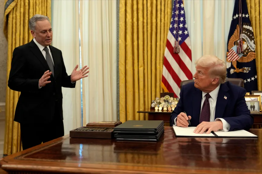 President Donald Trump listens to White House adviser David Sacks as he signs an executive order regarding cryptocurrency